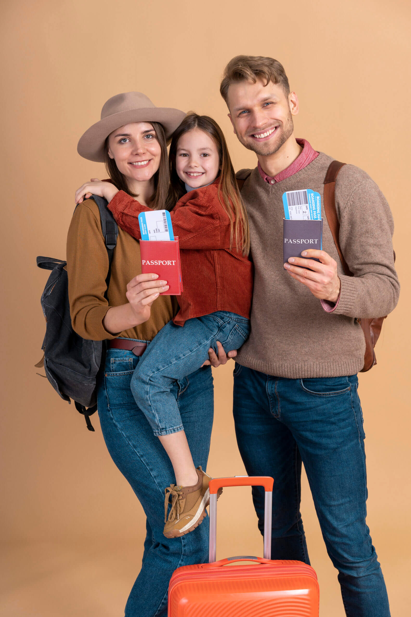 young-family-three-posing-together-before-travel-vacation-scaled